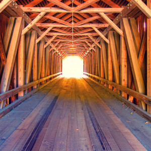 Light at the end of the tunnel, Inside wood covered bridge in Maine USA.