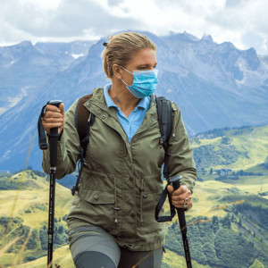 Hiker with face mask in mountains